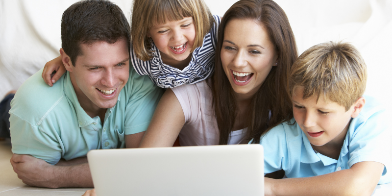 Family looking at a laptop together