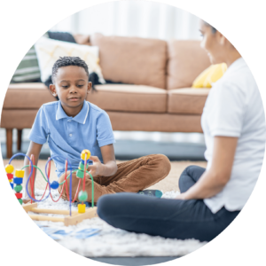 Child playing with a bead maze toy during an ABA therapy session