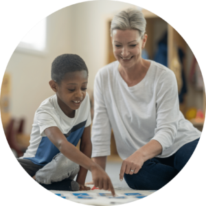 Speech therapist working with a child at a table activity