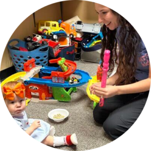 Occupational therapist playing with a toddler on the floor
